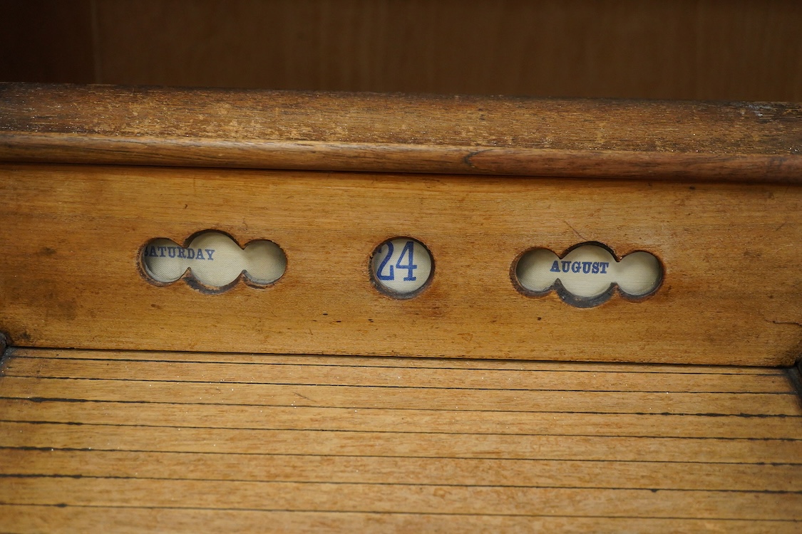 A Victorian mahogany stationery box with calendar and roll top, 34cm high